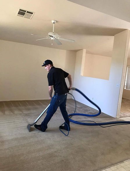 Technician steam-cleaning carpet