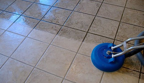 Technician cleaning tile and grout